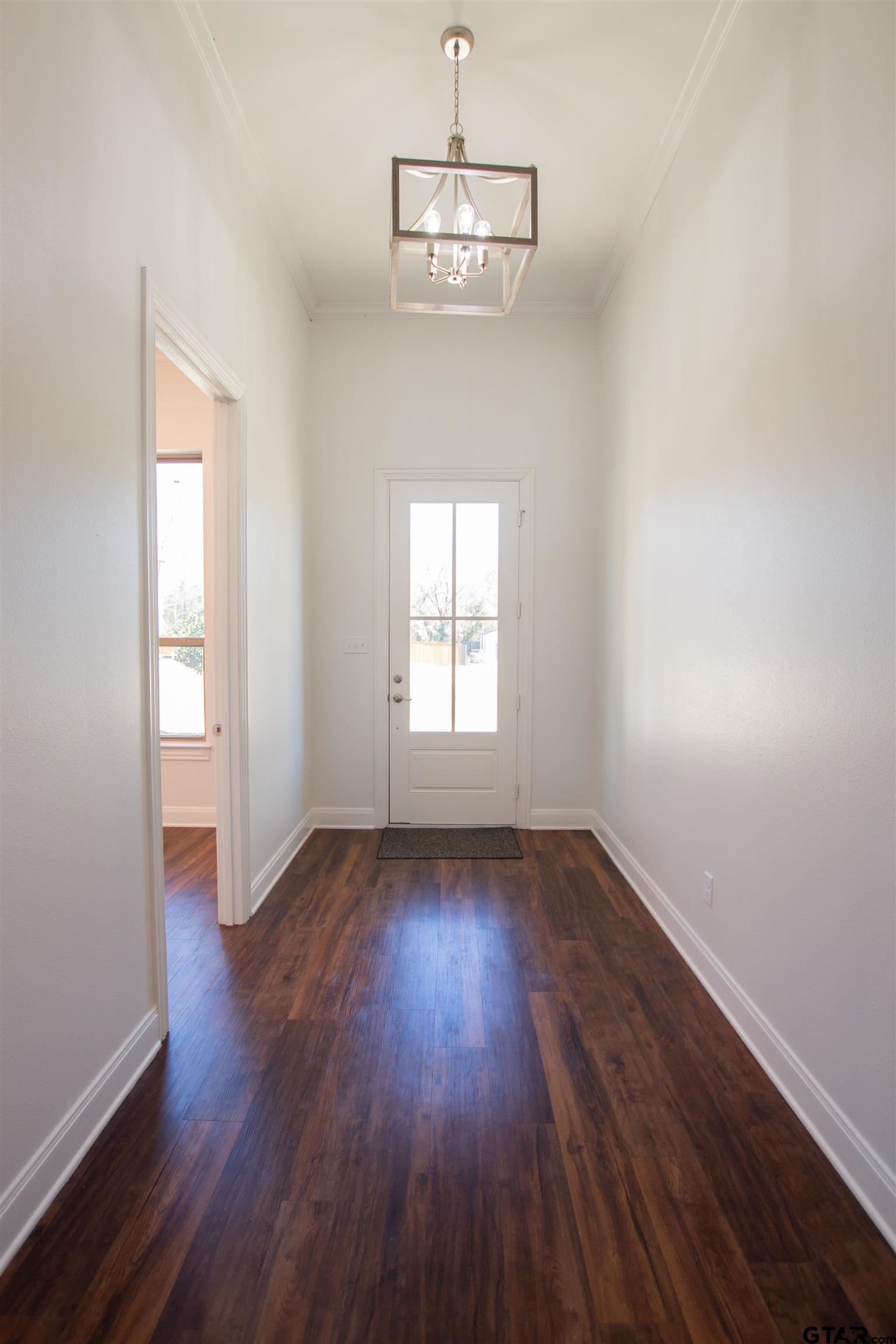 14716 Fallow Lane Tyler, TX 75706 - Photo 2 of 46 an empty room with wooden floor and windows