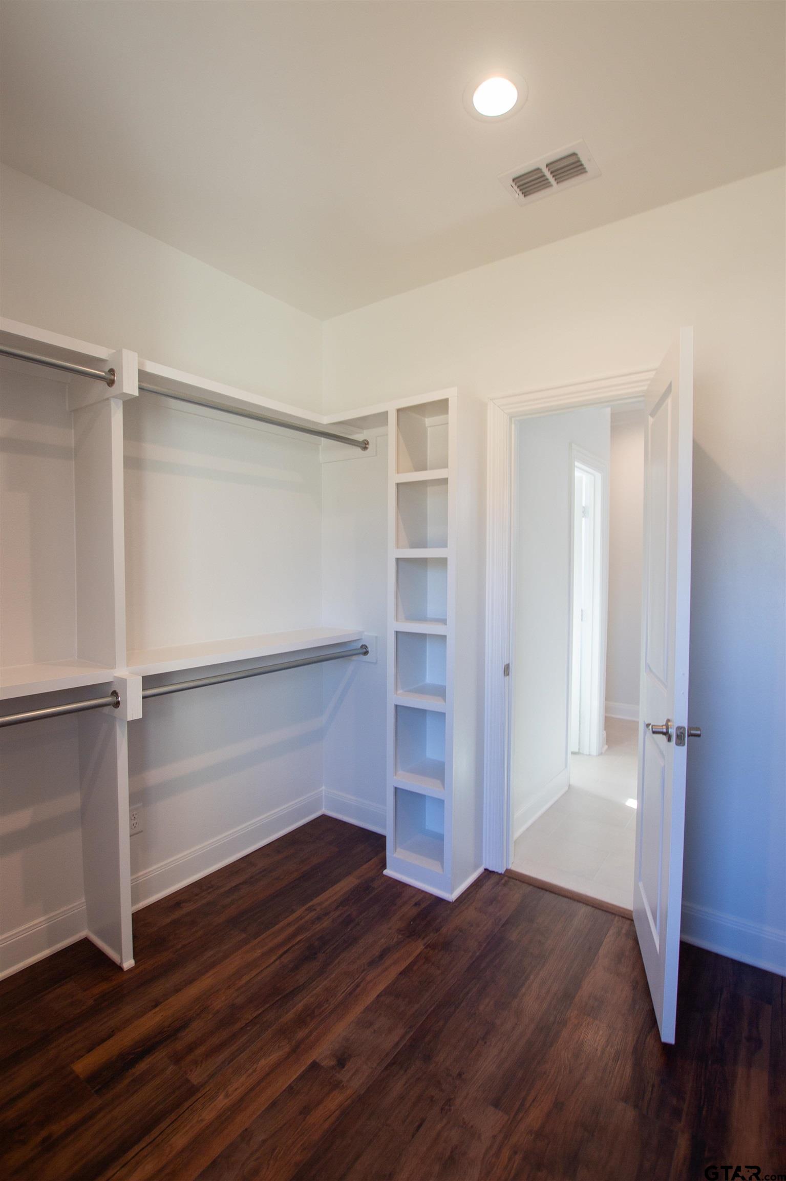 14716 Fallow Lane Tyler, TX 75706 - Photo 22 of 46 a view of walk in closet with empty racks