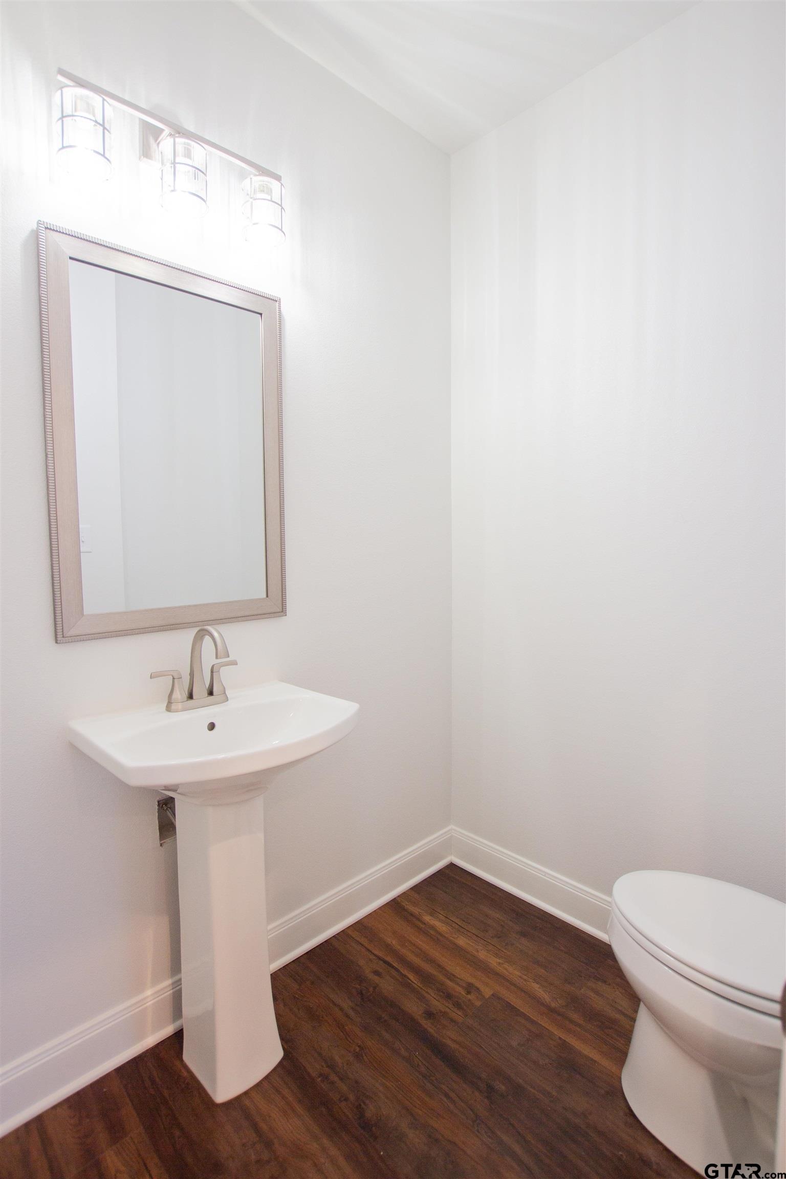 14716 Fallow Lane Tyler, TX 75706 - Photo 24 of 46 a bathroom with a toilet a sink and mirror