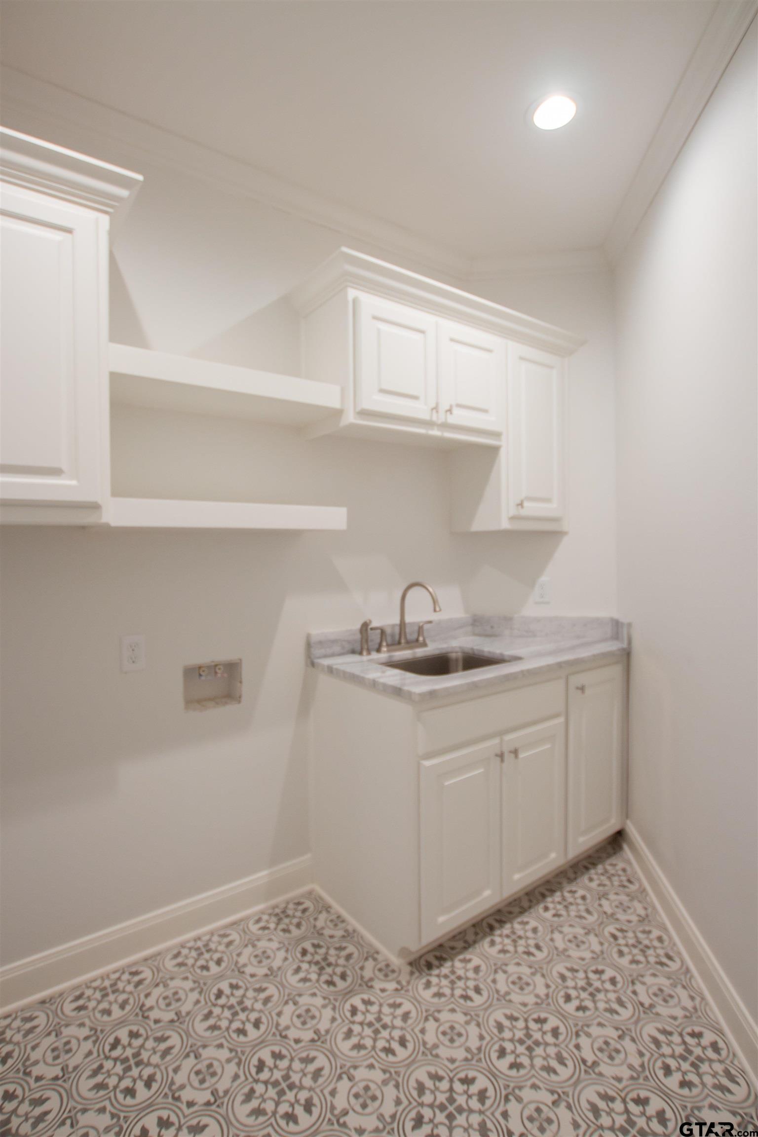 14716 Fallow Lane Tyler, TX 75706 - Photo 25 of 46 a kitchen with a sink a stove and cabinets