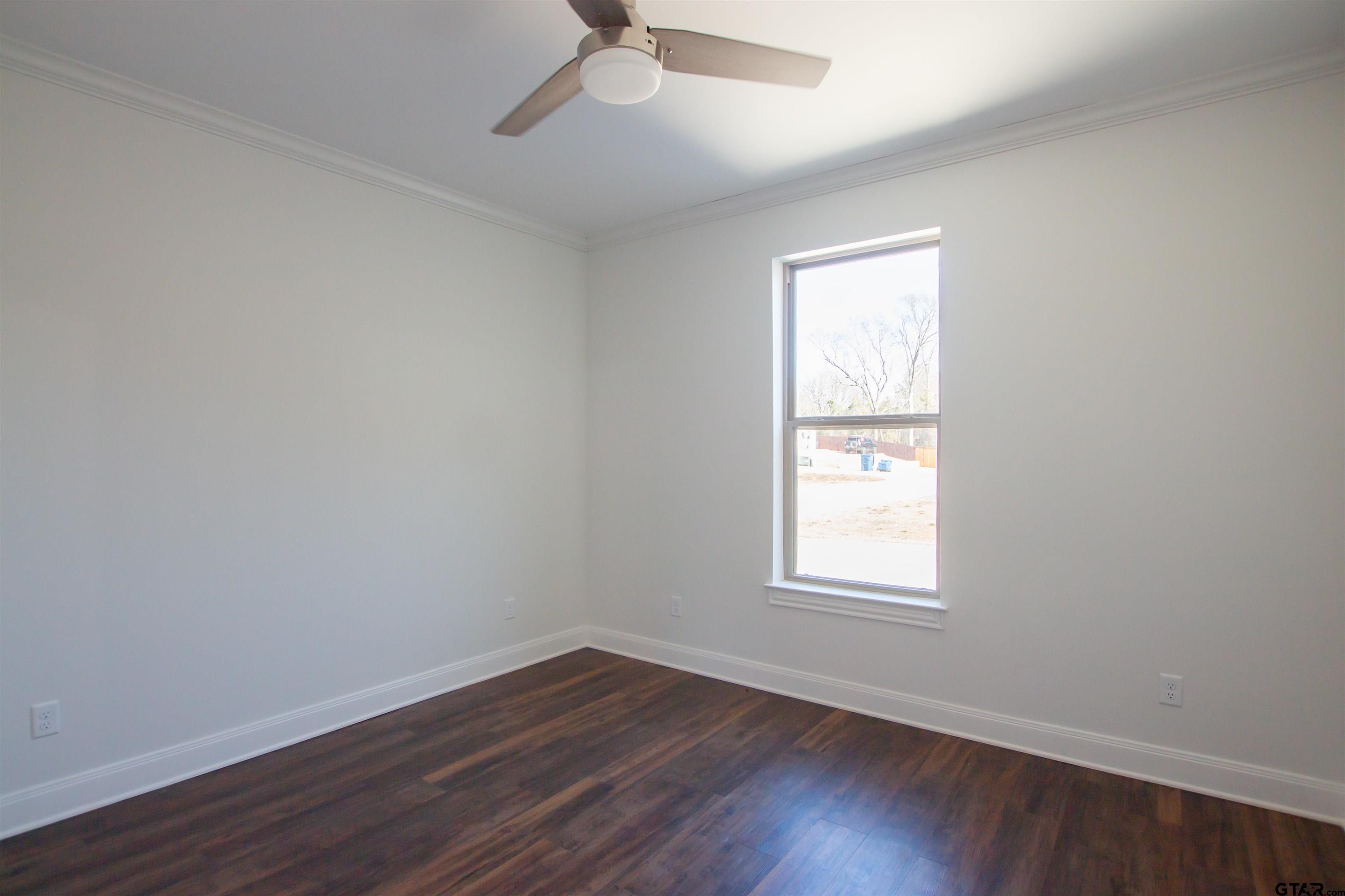 14716 Fallow Lane Tyler, TX 75706 - Photo 26 of 46 an empty room with wooden floor and windows