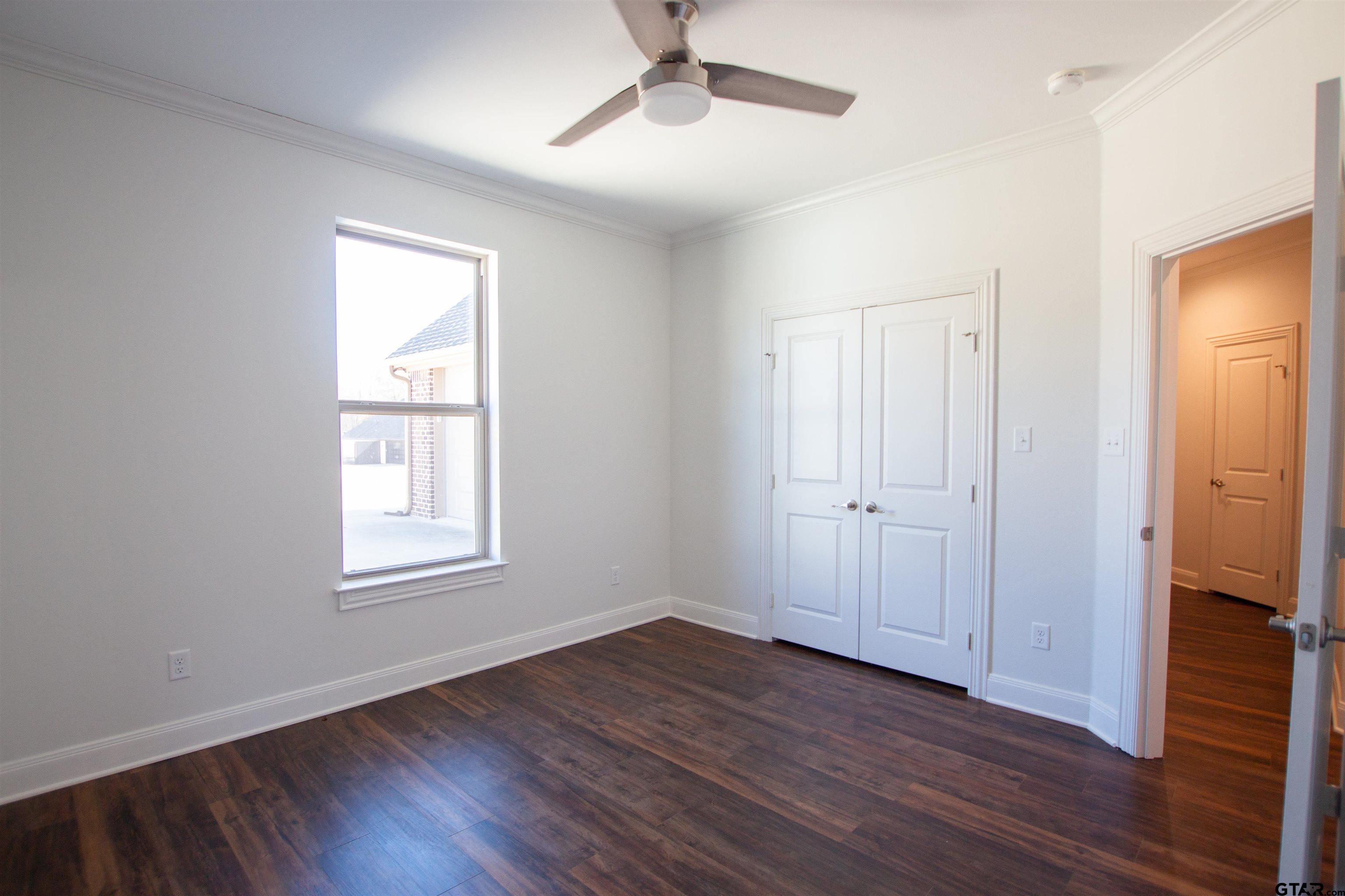 14716 Fallow Lane Tyler, TX 75706 - Photo 27 of 46 a view of an empty room with wooden floor and a window
