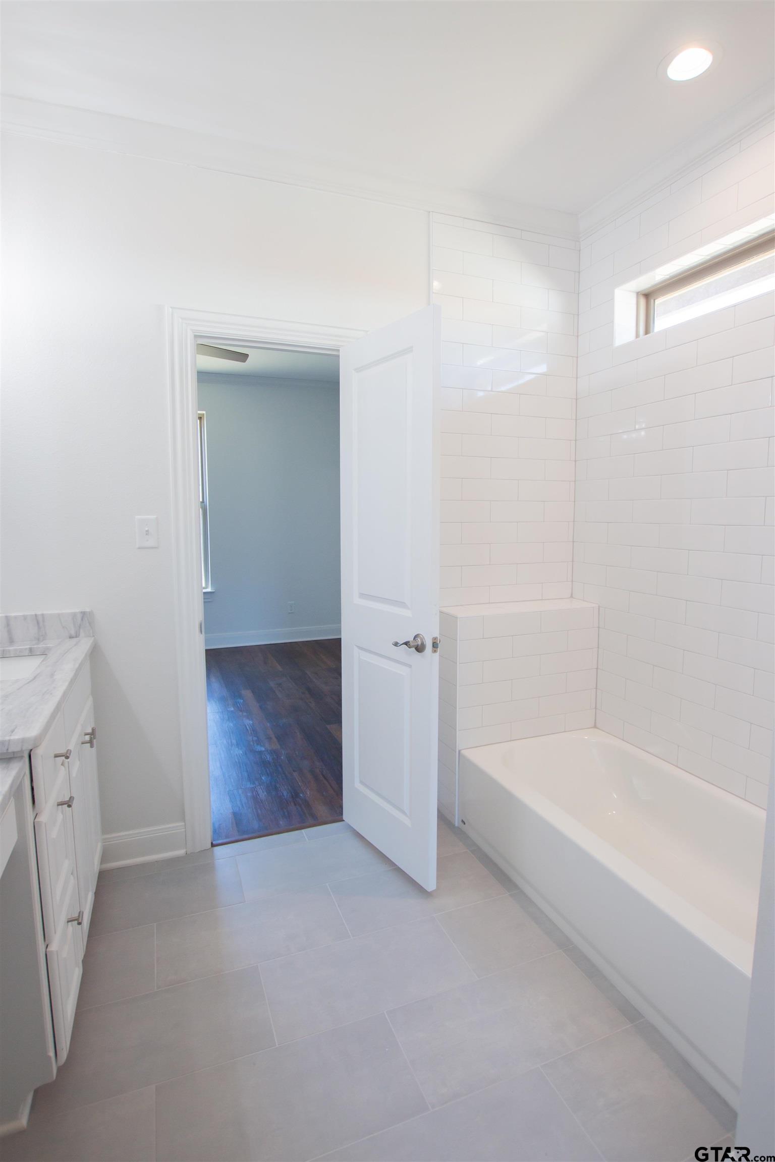 14716 Fallow Lane Tyler, TX 75706 - Photo 28 of 46 a spacious bathroom with a bathtub sink and mirror