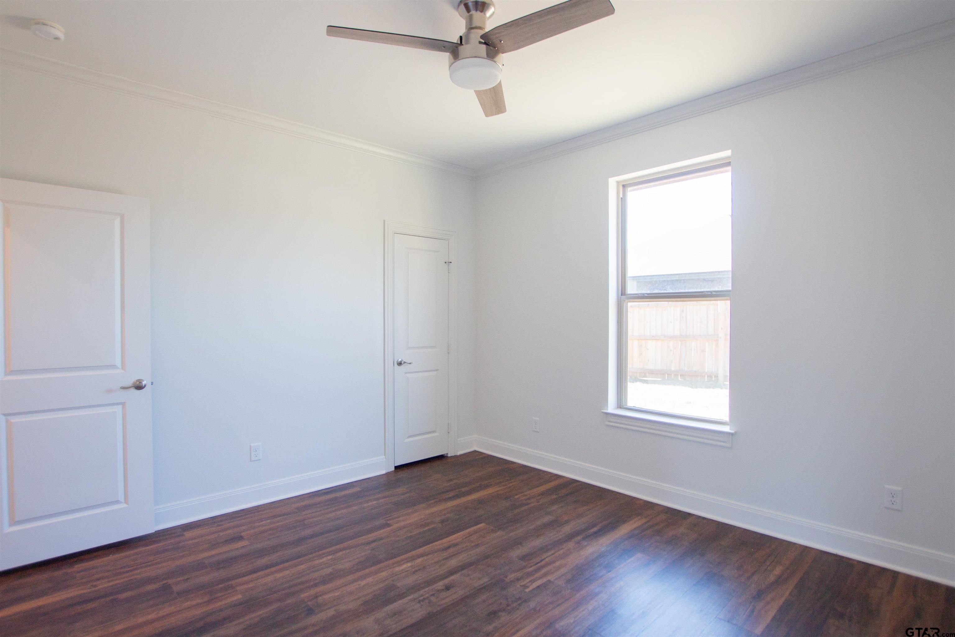 14716 Fallow Lane Tyler, TX 75706 - Photo 29 of 46 an empty room with wooden floor and windows