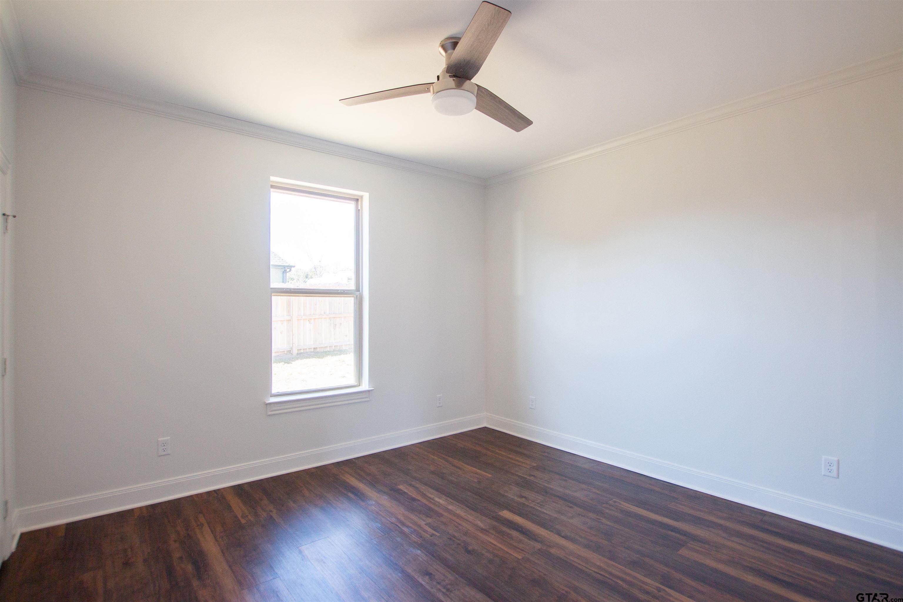14716 Fallow Lane Tyler, TX 75706 - Photo 30 of 46 an empty room with wooden floor and windows