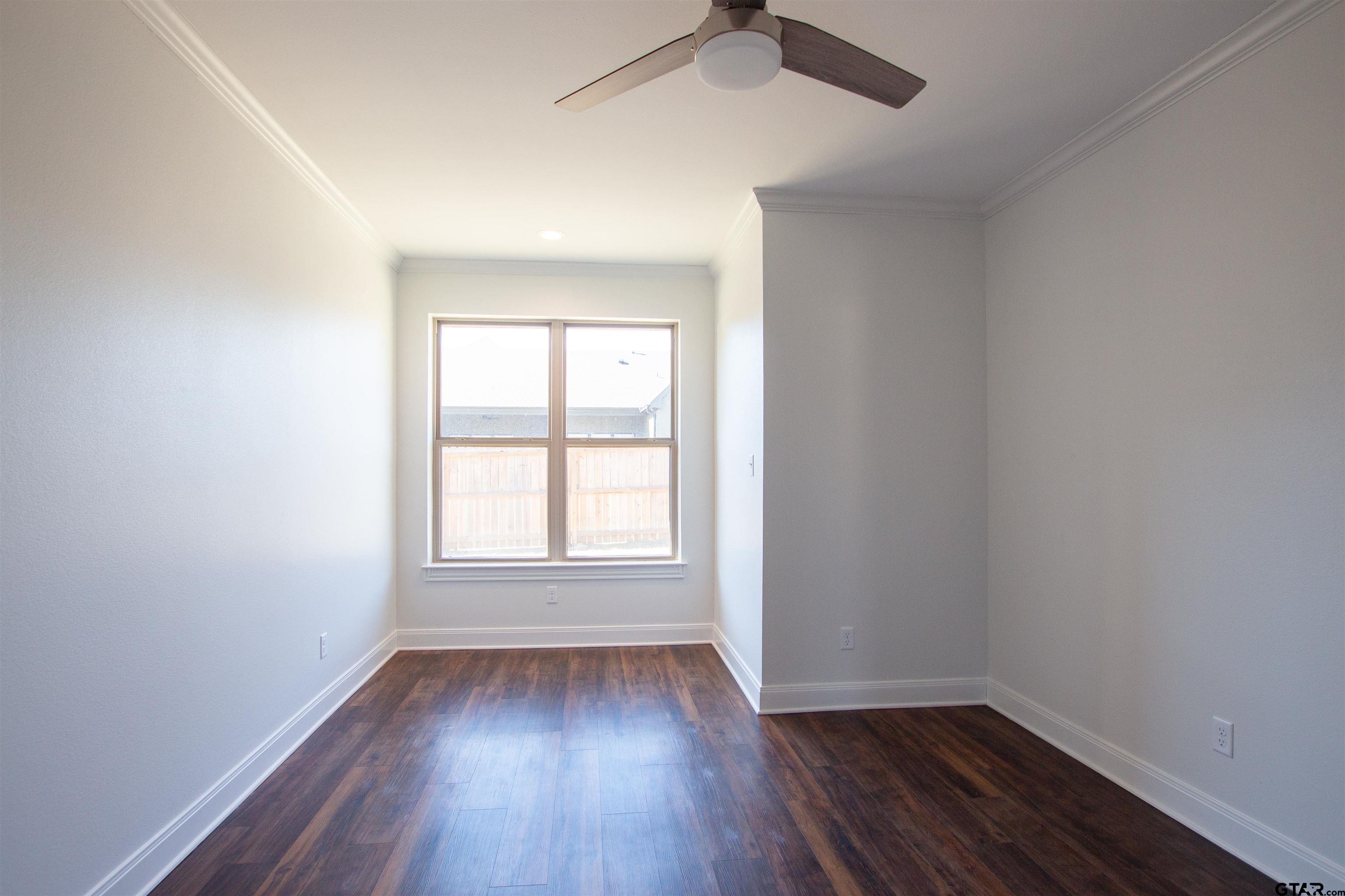 14716 Fallow Lane Tyler, TX 75706 - Photo 33 of 46 an empty room with wooden floor and windows