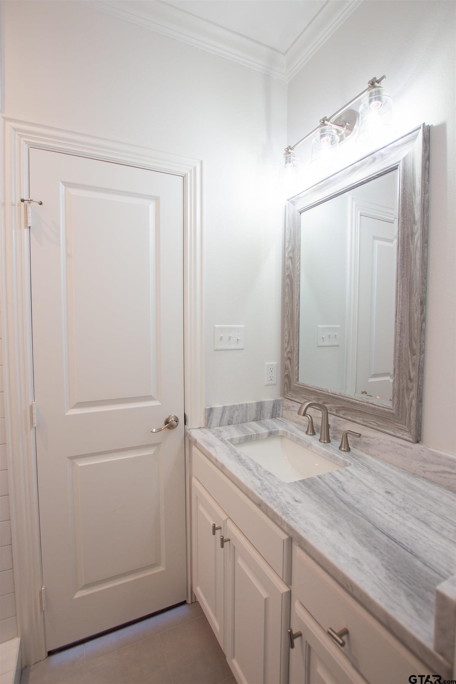 14716 Fallow Lane Tyler, TX 75706 - Photo 35 of 46 a bathroom with a granite countertop sink and mirror