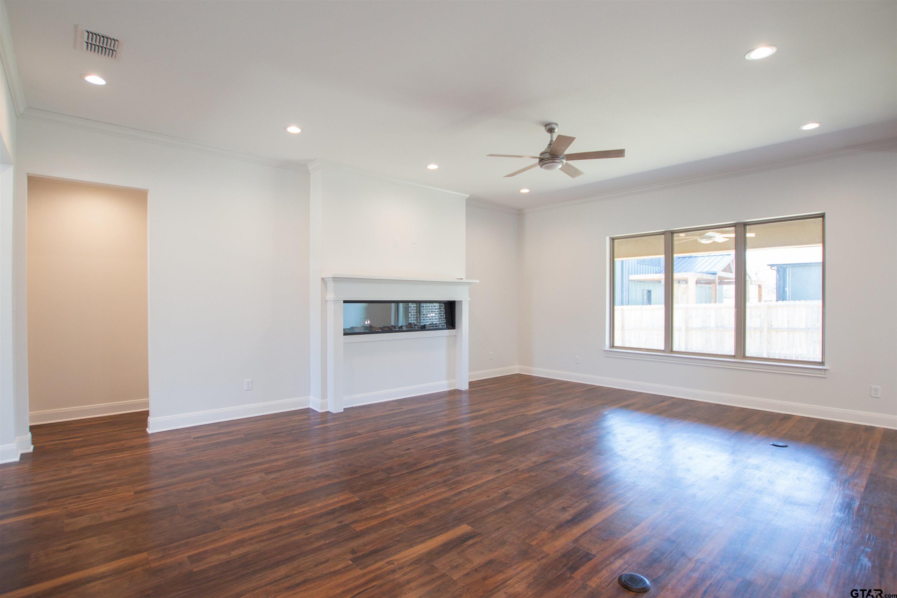 14716 Fallow Lane Tyler, TX 75706 - Photo 4 of 46 a view of an empty room with a window and wooden floor