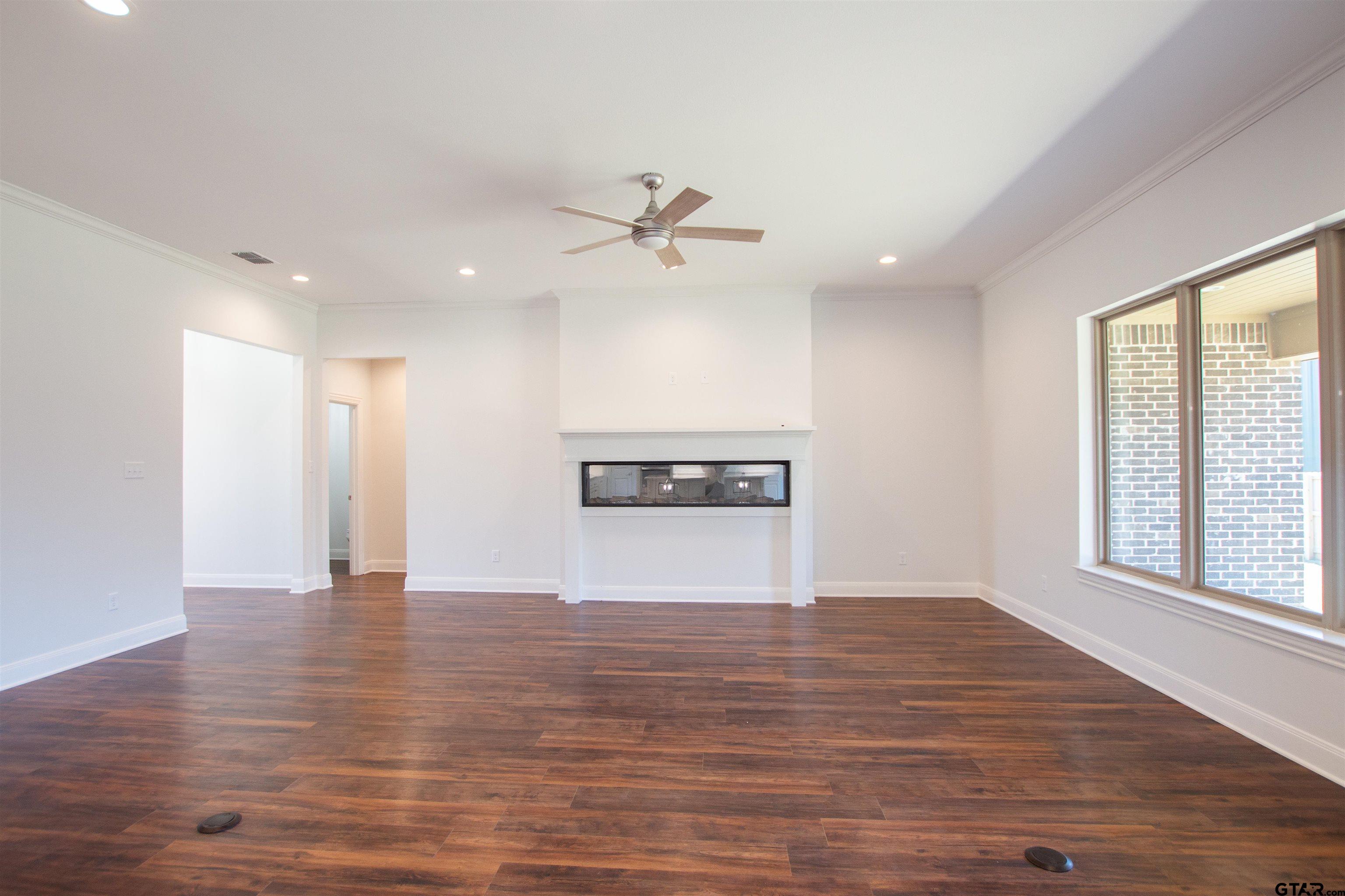 14716 Fallow Lane Tyler, TX 75706 - Photo 5 of 46 a view of an empty room with a window and wooden floor