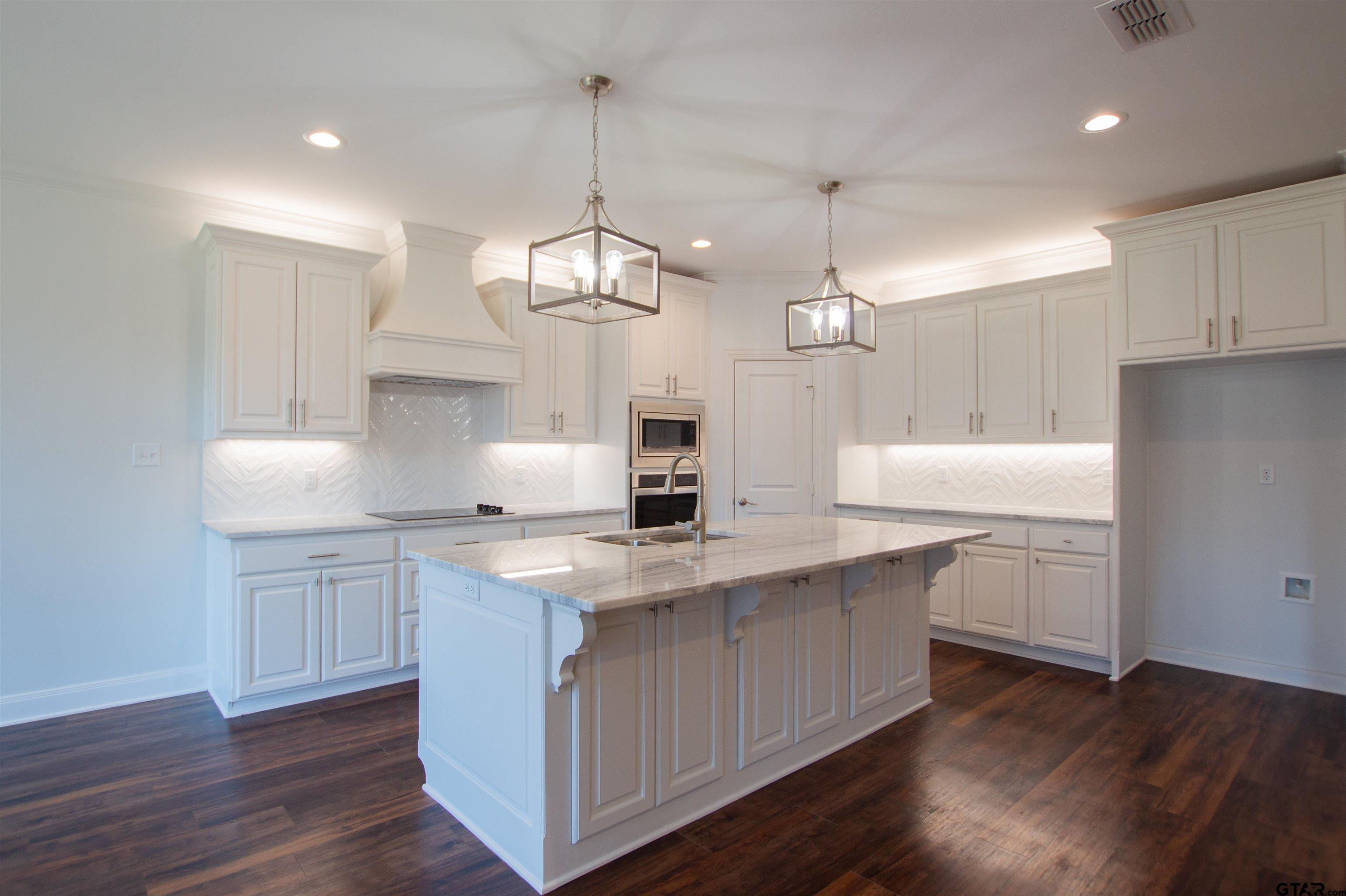 14716 Fallow Lane Tyler, TX 75706 - Photo 6 of 46 a kitchen with kitchen island granite countertop a sink a counter space appliances and cabinets