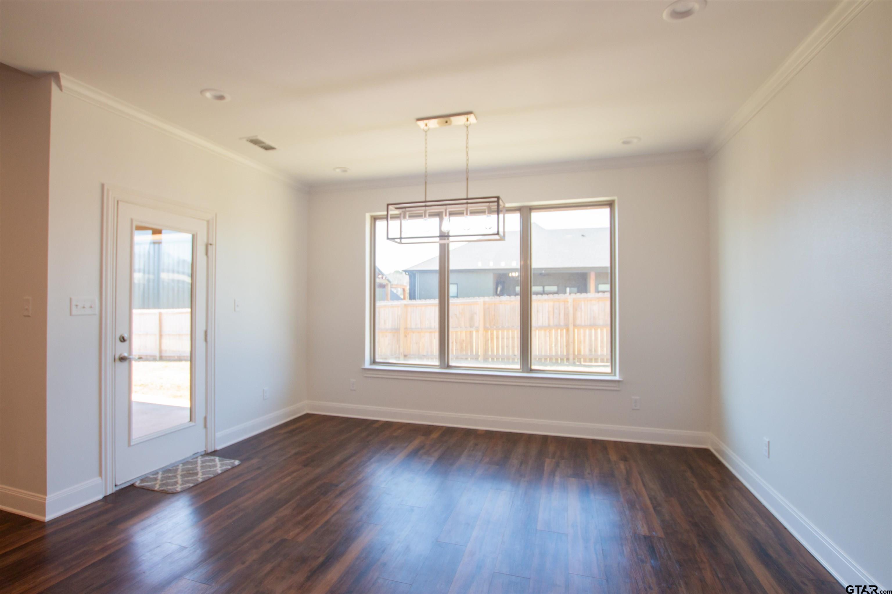 14716 Fallow Lane Tyler, TX 75706 - Photo 9 of 46 an empty room with wooden floor and windows