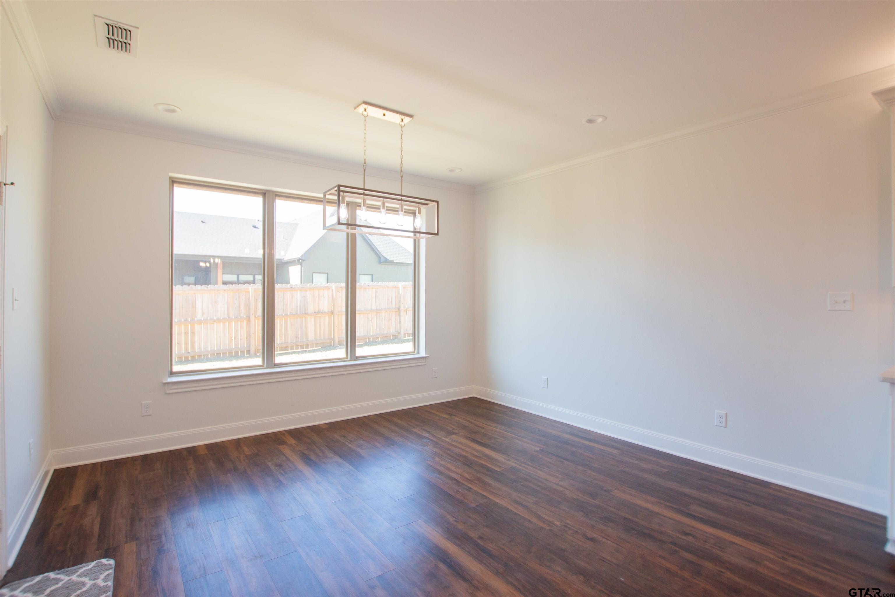 14716 Fallow Lane Tyler, TX 75706 - Photo 10 of 46 an empty room with wooden floor and windows