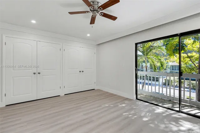 an empty room with wooden floor and window
