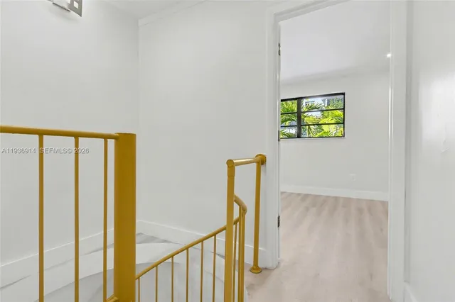 an aerial view of a house with a yard and large trees