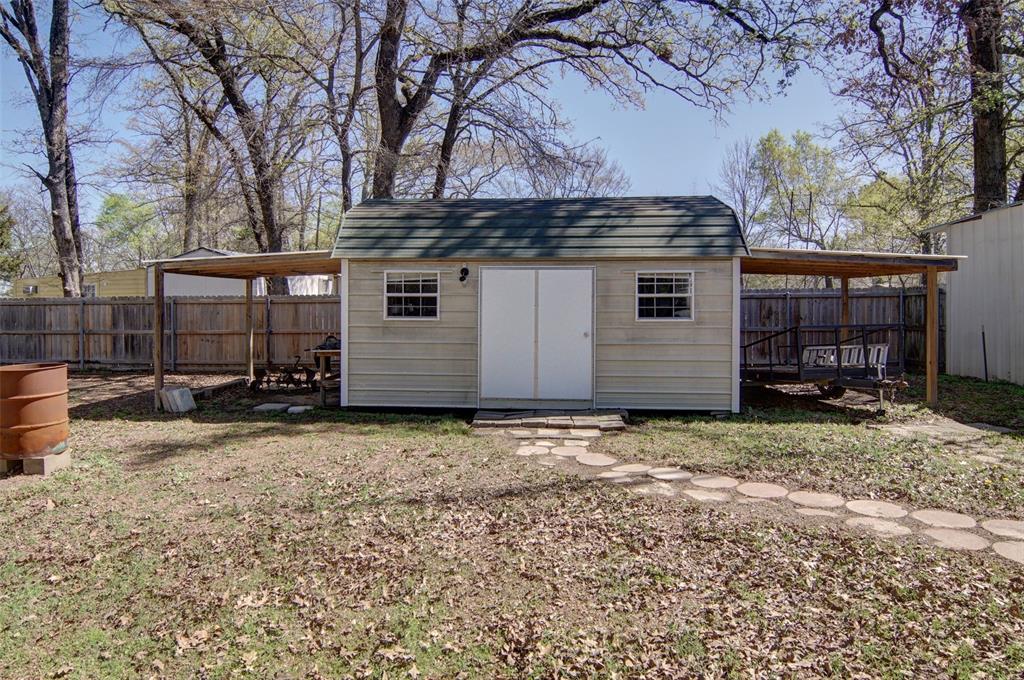 190 County Road 1975 Yantis, TX 75497 - Photo 31 of 36 a backyard of a house with barbeque oven and outdoor seating