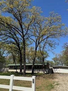 190 County Road 1975 Yantis, TX 75497 - Photo 35 of 36 a view of house with large trees in the background