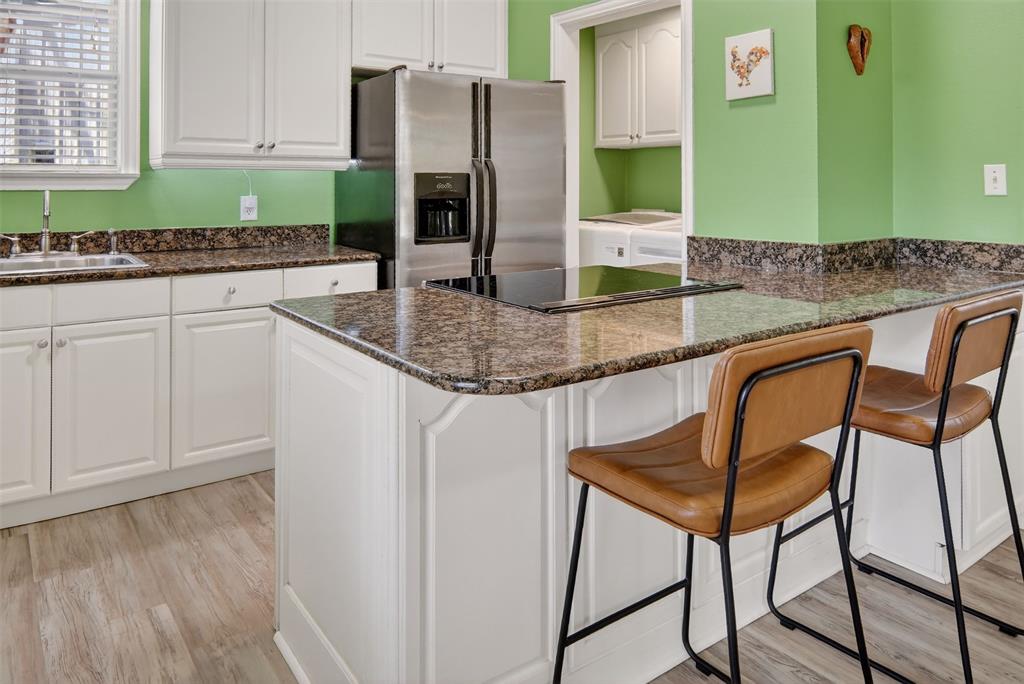 190 County Road 1975 Yantis, TX 75497 - Photo 9 of 36 a kitchen with stainless steel appliances granite countertop a table and chairs in it