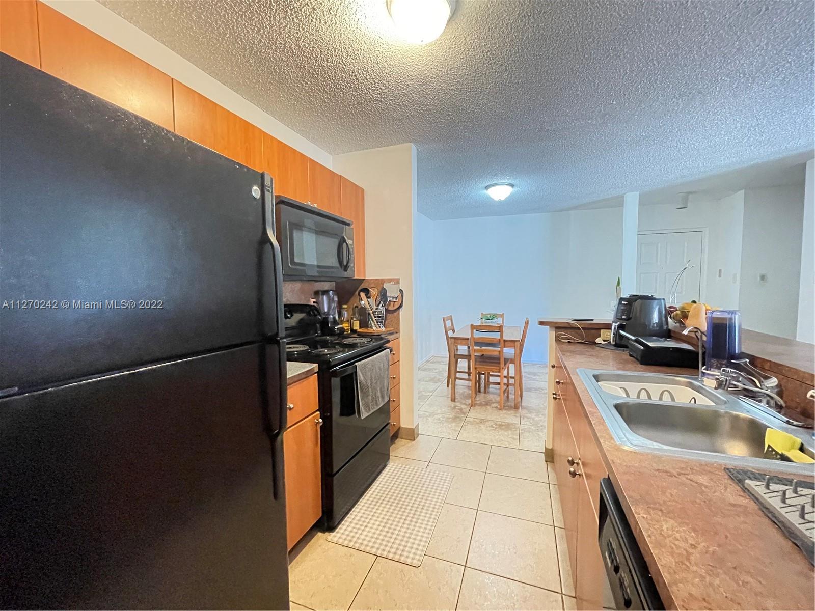 The Hammocks Miami, FL 33196 - Photo 11 of 21 a kitchen with granite countertop a refrigerator stove and oven
