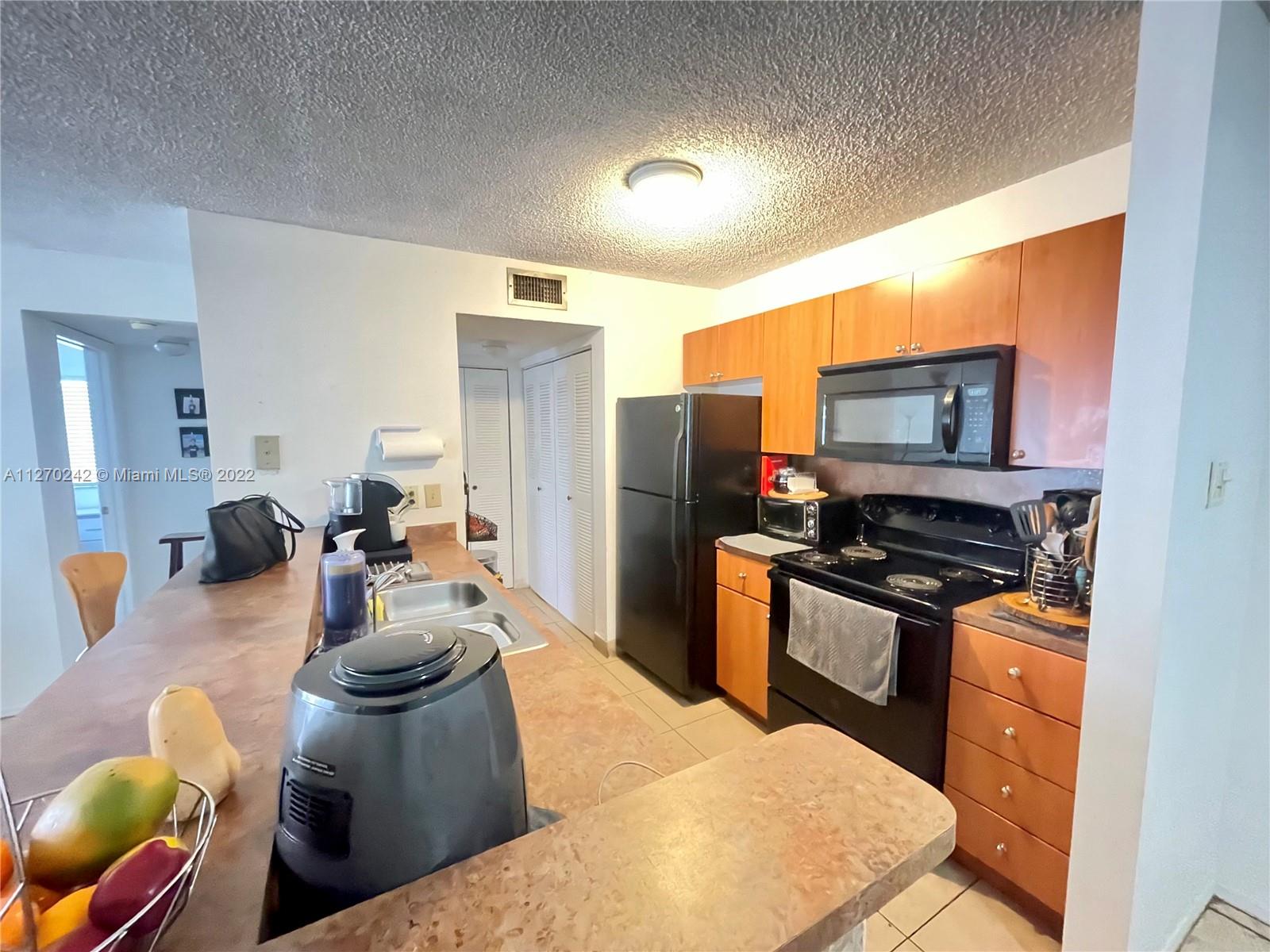 The Hammocks Miami, FL 33196 - Photo 12 of 21 a kitchen with stainless steel appliances kitchen island granite countertop a sink and cabinets