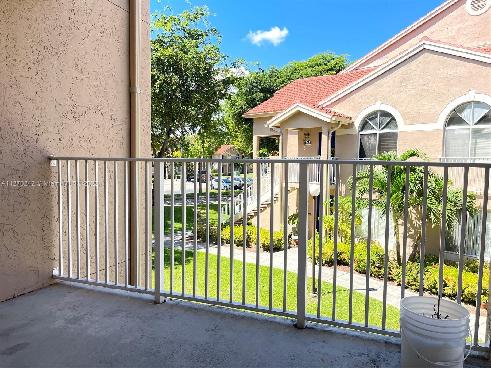 The Hammocks Miami, FL 33196 - Photo 13 of 21 a view of a white house with a large windows and plants