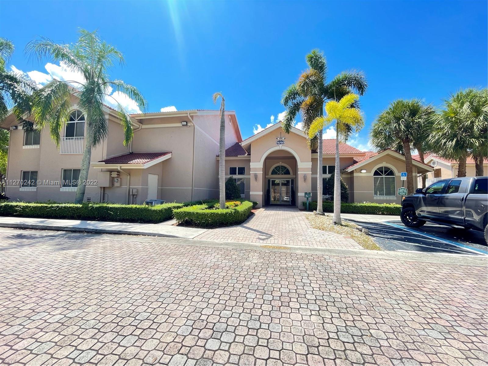 The Hammocks Miami, FL 33196 - Photo 18 of 21 a view of a white house with a yard and potted plants