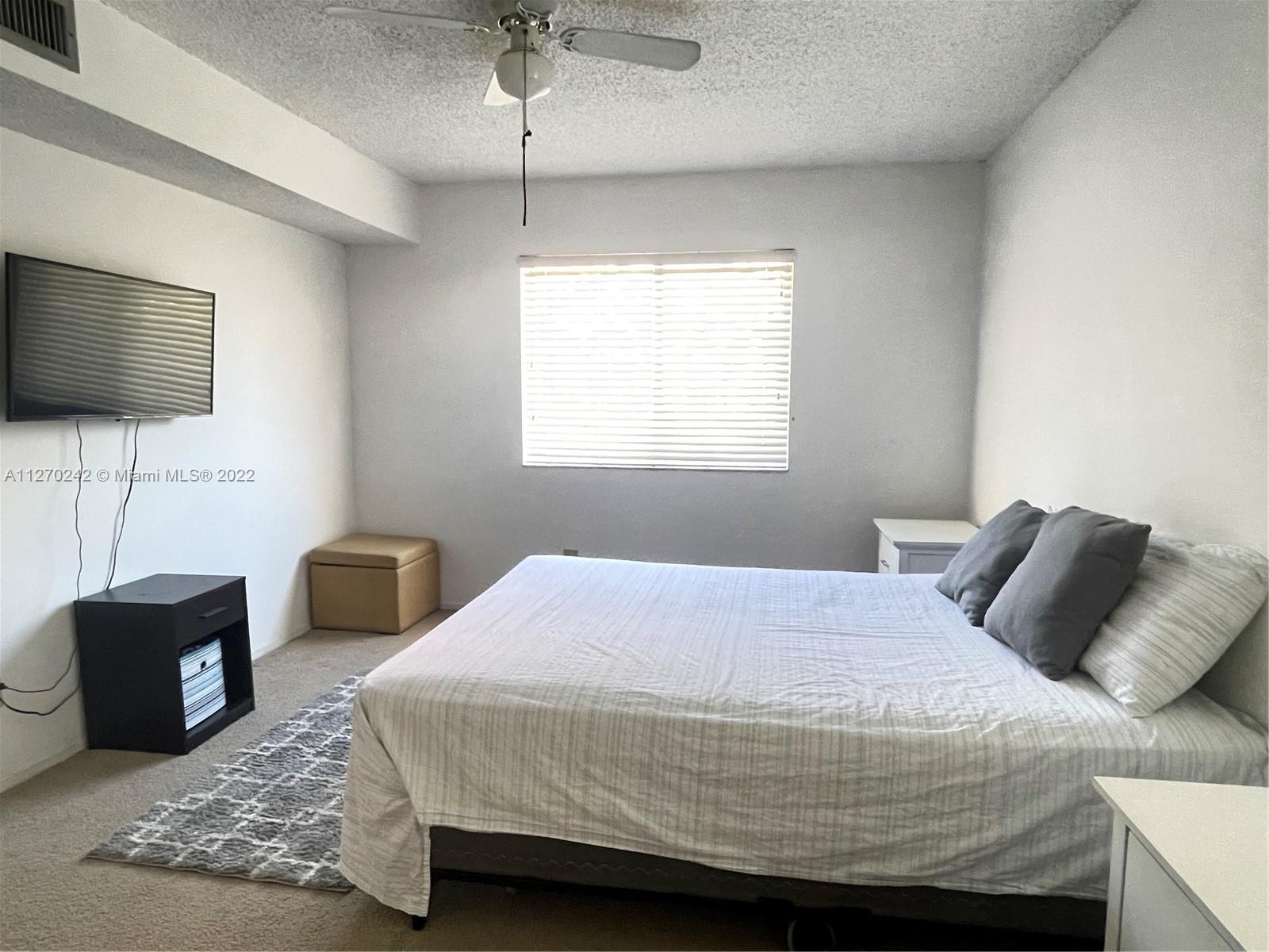 The Hammocks Miami, FL 33196 - Photo 9 of 21 a bedroom with a bed and a flat screen tv