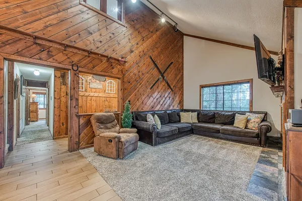 a living room with furniture a flat screen tv and a fireplace