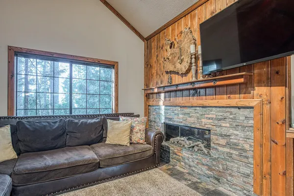 a living room with furniture a flat screen tv and a fireplace