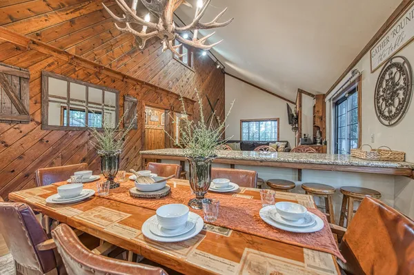a dining room with furniture and wooden floor