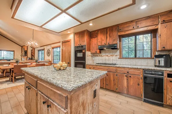 a kitchen with stainless steel appliances granite countertop a stove and a sink