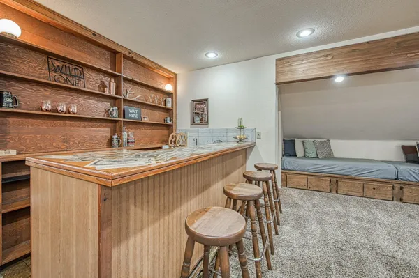 a room with pool table table and windows