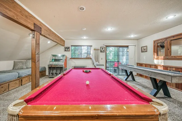 a room with furniture and pool table