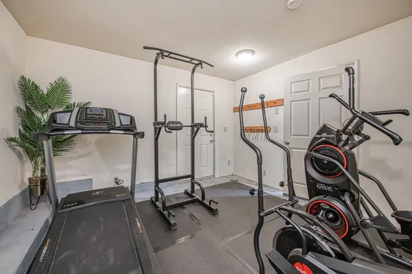 a bedroom with furniture and a large window