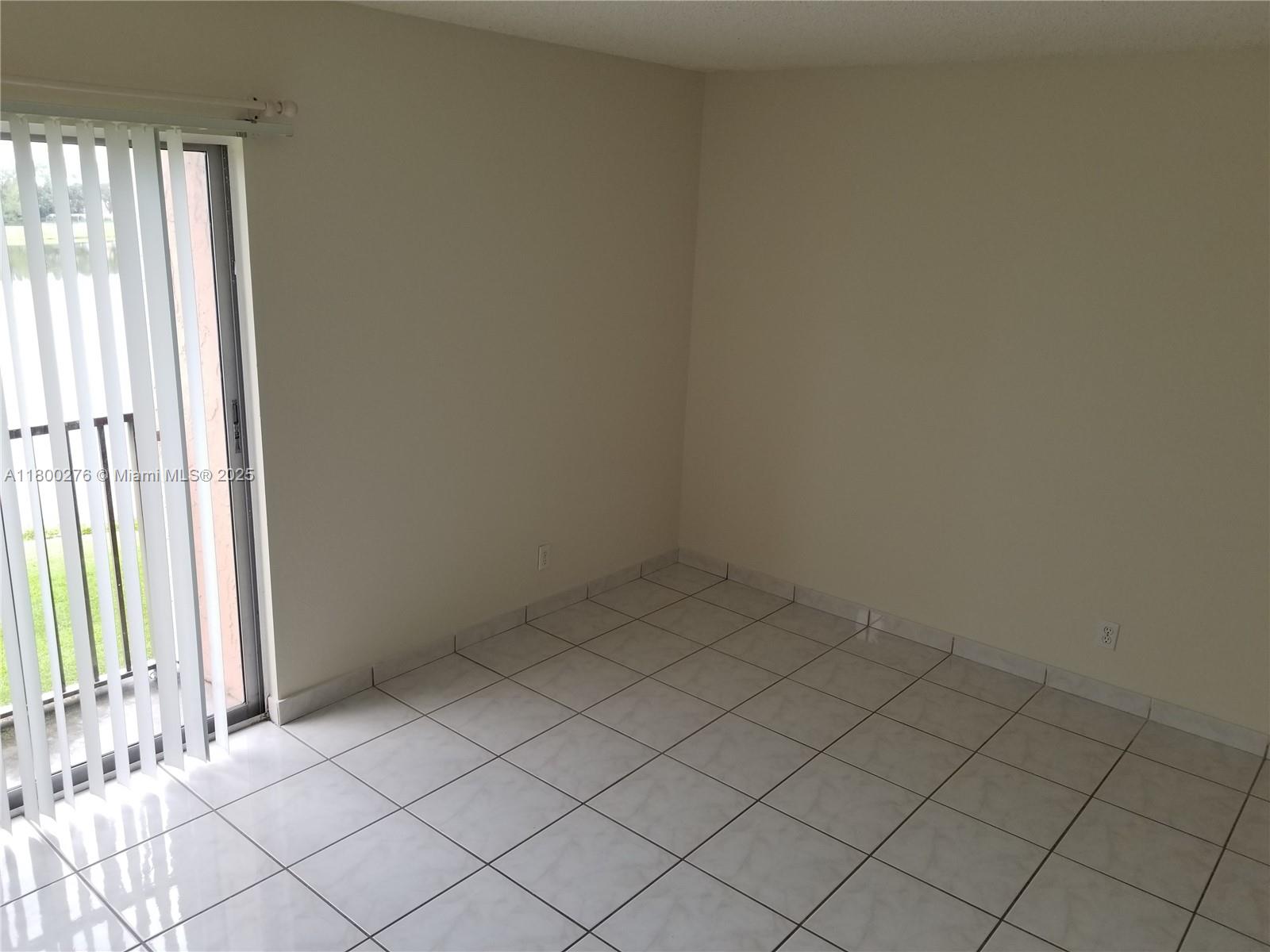 8560 Sherman Circle North, Unit 402 Miramar, FL 33025 - Photo 8 of 19 an empty room with windows