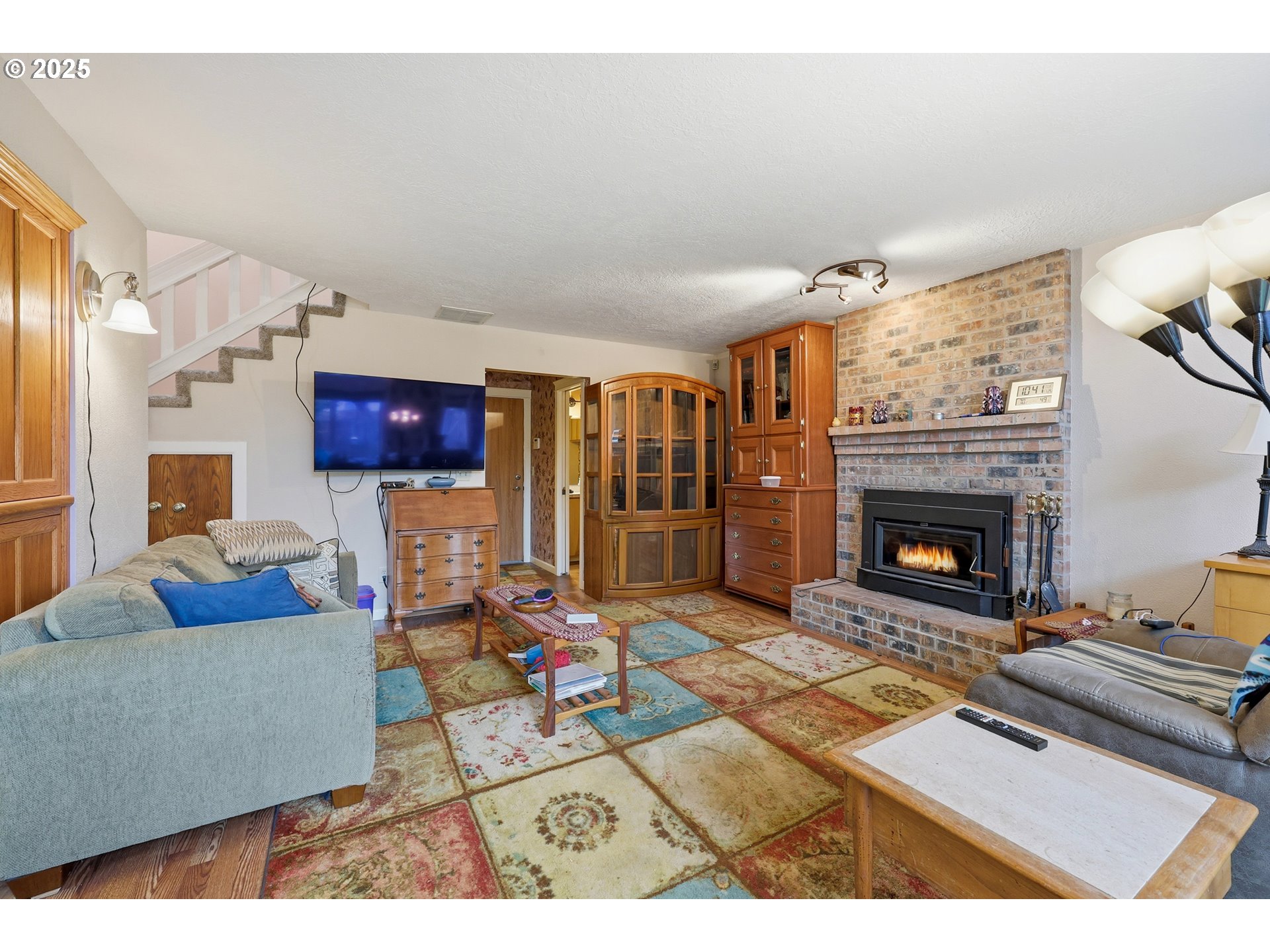 3749 Southwest 6th Street Gresham, OR 97030 - Photo 17 of 41 a living room with furniture a flat screen tv and a fireplace