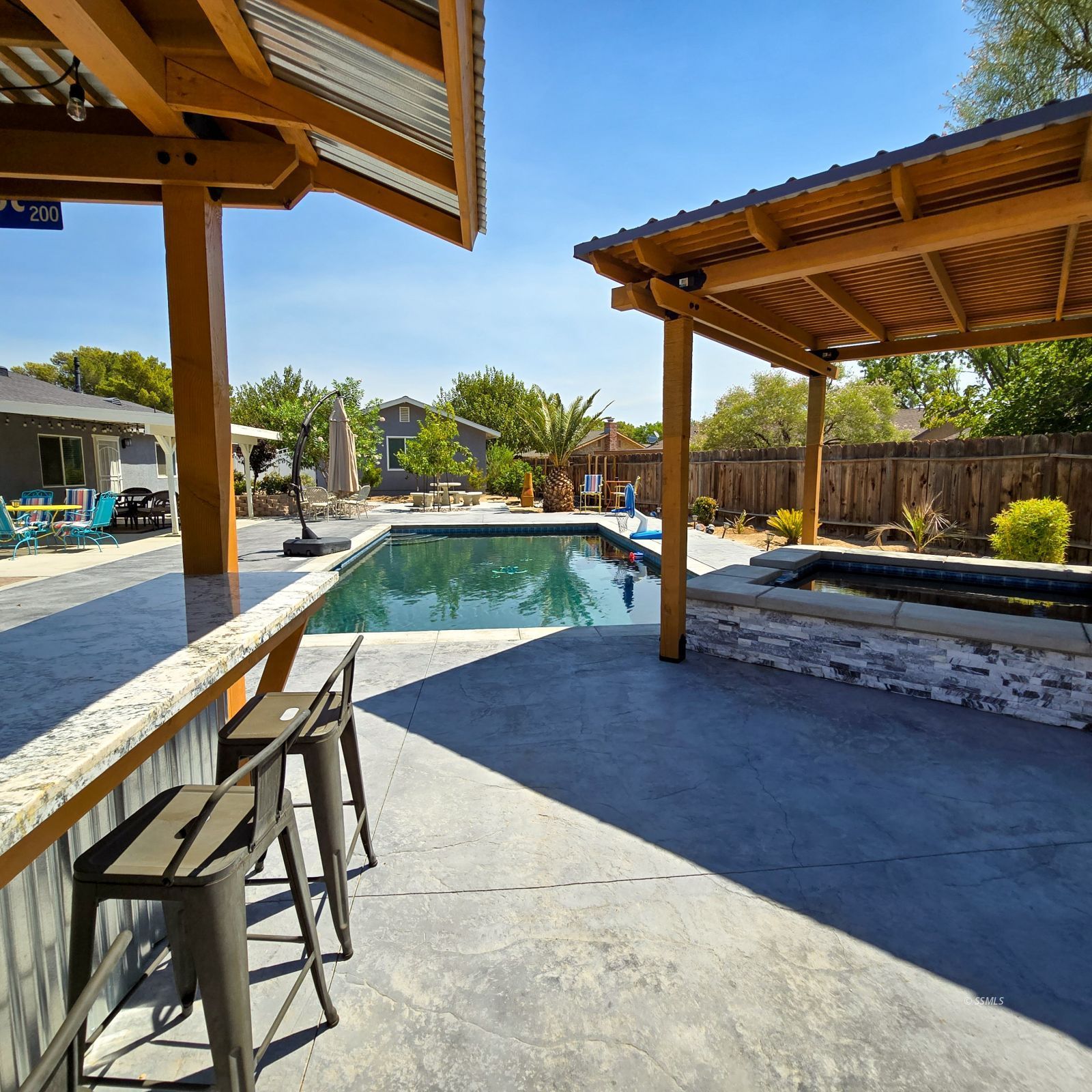 316 South Lilac Street Ridgecrest, CA 93555 - Photo 40 of 45 a patio with a table and chairs under an umbrella