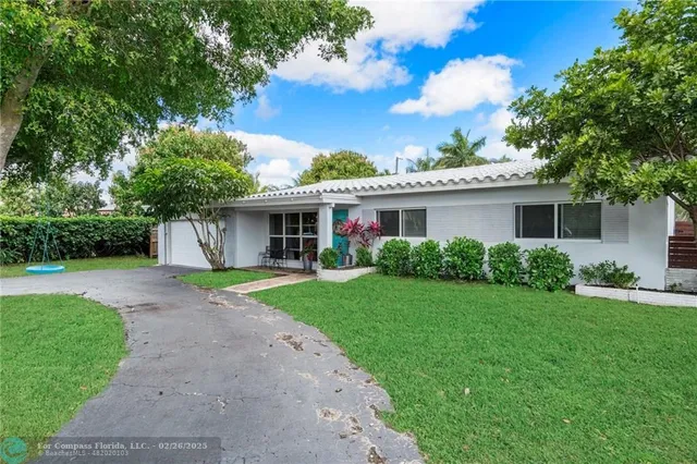 a front view of house with a garden