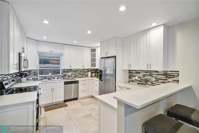 a kitchen with refrigerator and stove