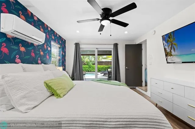 a bedroom with a large bed and a flat screen tv