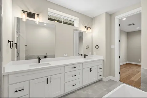 a bathroom with a double vanity sink mirror and double