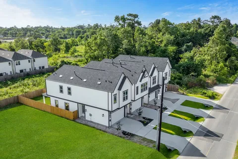 an aerial view of a house with a big yard