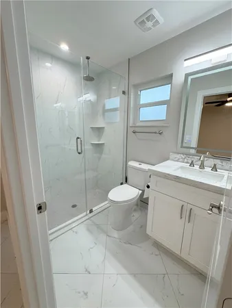 a bathroom with a sink toilet and shower