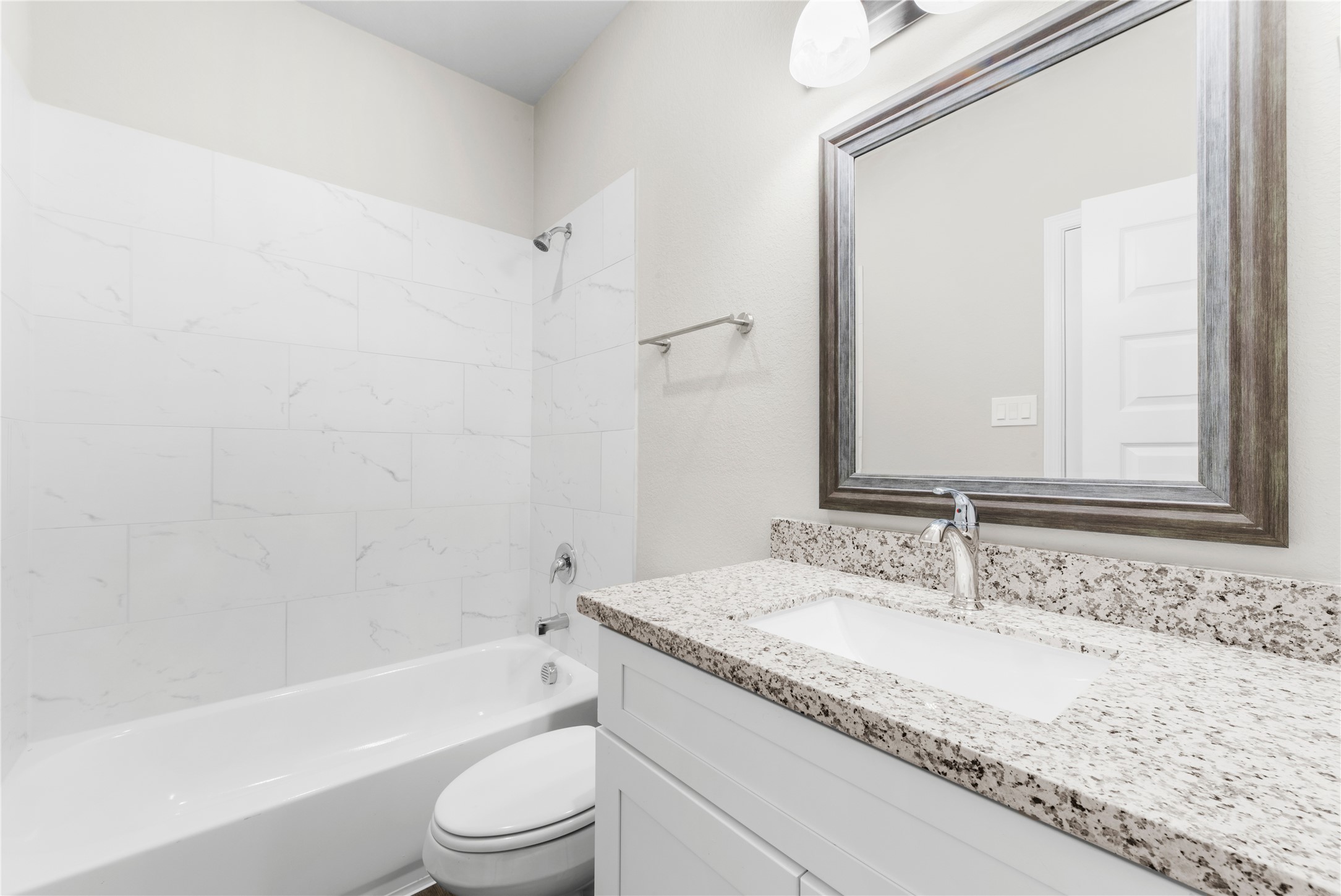 8161 Tate Street, Unit B Houston, TX 77028 - Photo 8 of 14 a bathroom with a granite countertop sink toilet and shower