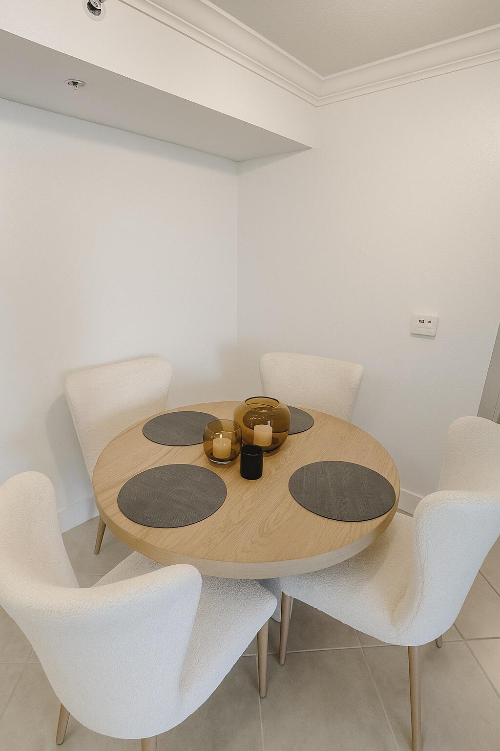 15135 Michelangelo Boulevard, Unit 108 Delray Beach, FL 33446 - Photo 6 of 17 a dining room with furniture and wooden floor