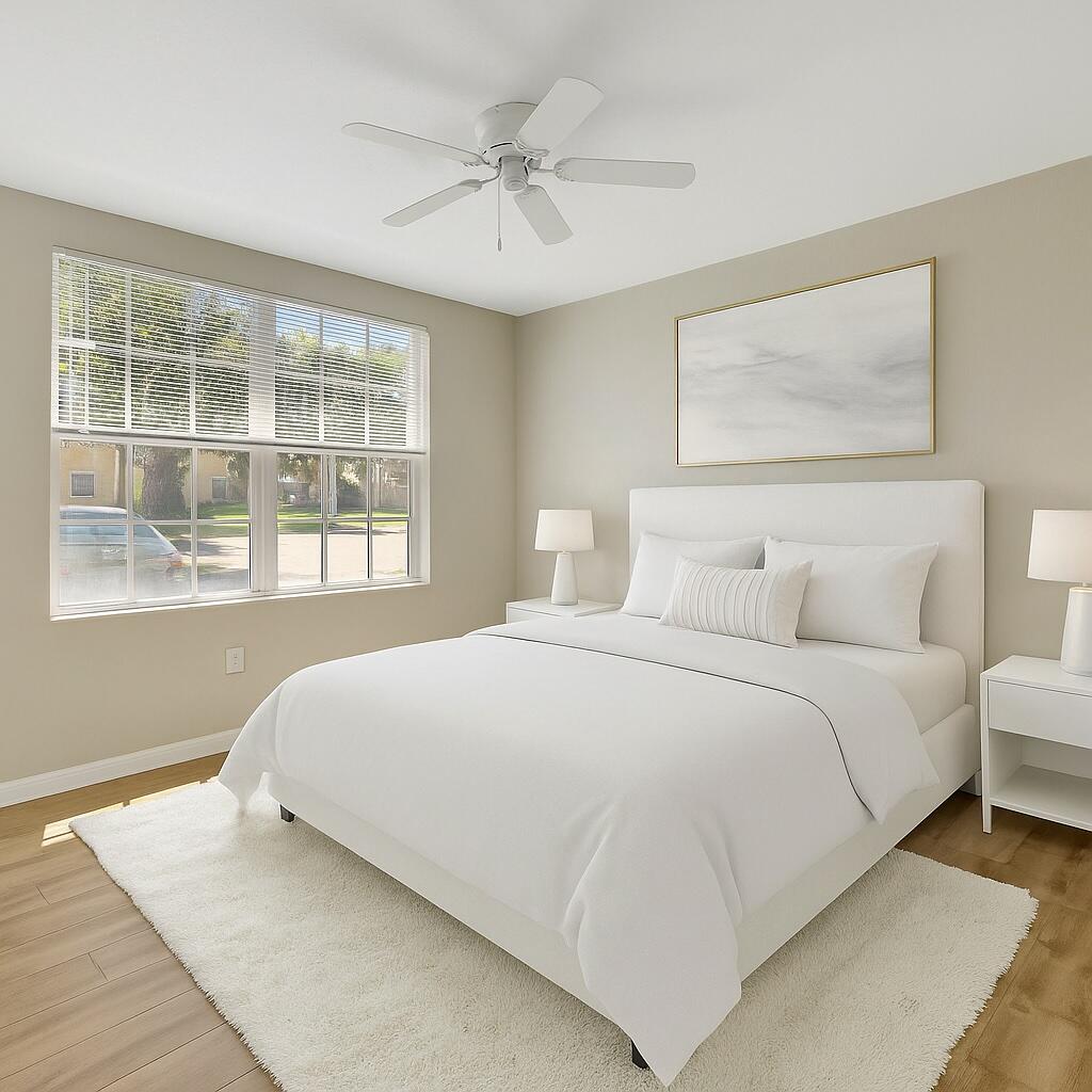 15135 Michelangelo Boulevard, Unit 108 Delray Beach, FL 33446 - Photo 8 of 17 a bedroom with a large bed and a window