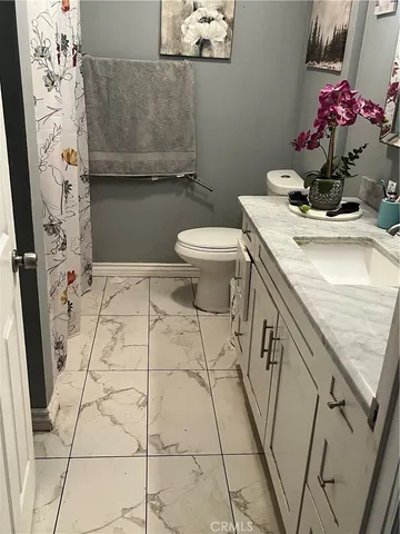 a bathroom with a sink toilet and mirror