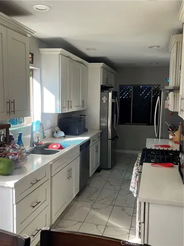 a kitchen with a stove and a refrigerator