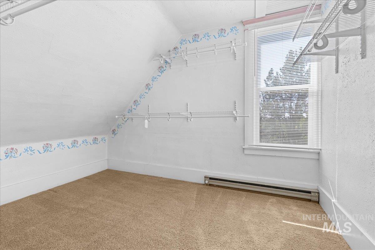 5611 West Hill Road Boise, ID 83703 - Photo 26 of 48 Featuring lofted ceiling, carpet floors, and a baseboard heating unit
