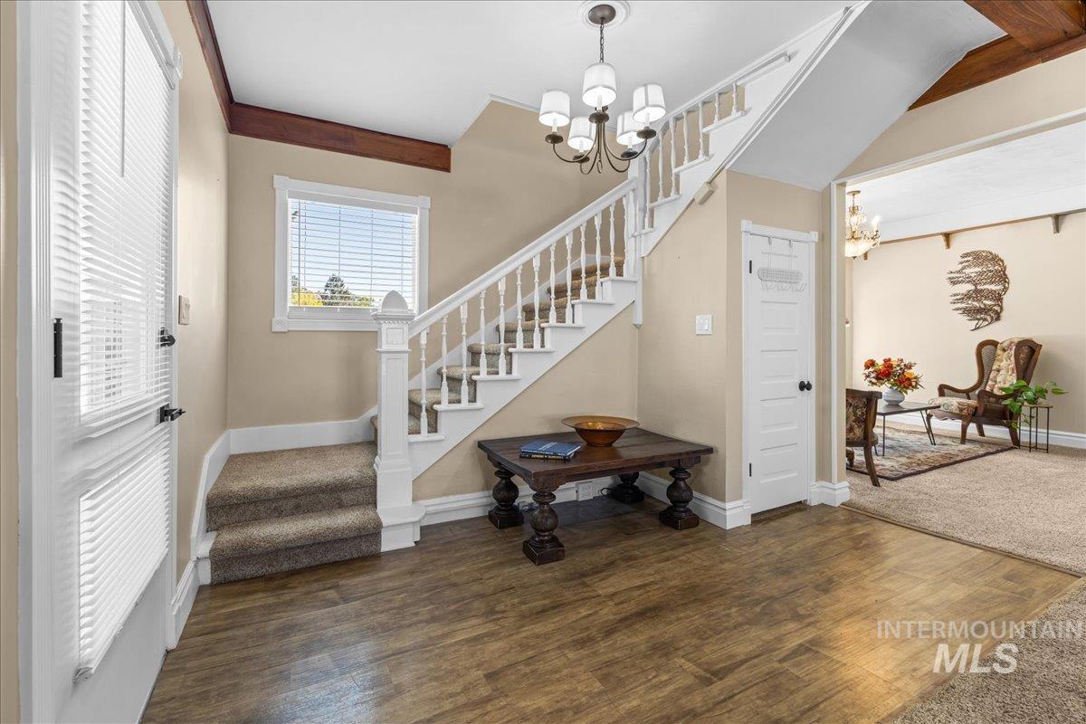 5611 West Hill Road Boise, ID 83703 - Photo 3 of 48 Entrance foyer featuring a chandelier, stairway, and dark wood-style flooring