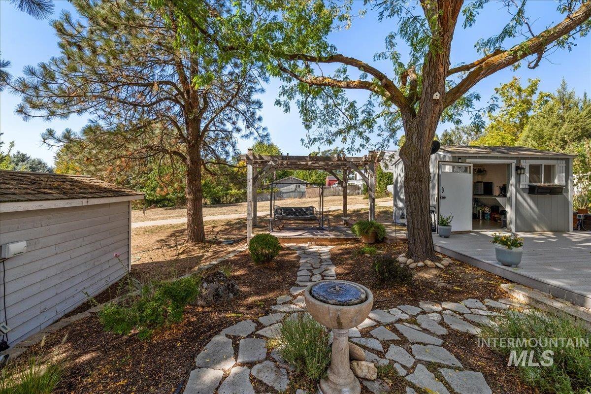 5611 West Hill Road Boise, ID 83703 - Photo 40 of 48 With a patio area, a pergola, a storage shed, and a wooden deck